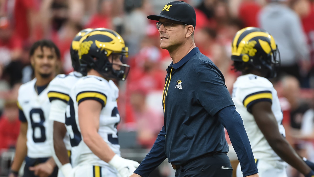 Chargers coach Jim Harbaugh to serve as honorary captain at Michigan’s season opener despite NCAA penalties