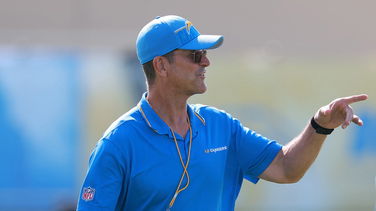 Chargers coach Jim Harbaugh to serve as honorary captain at Michigan’s season opener despite NCAA penalties